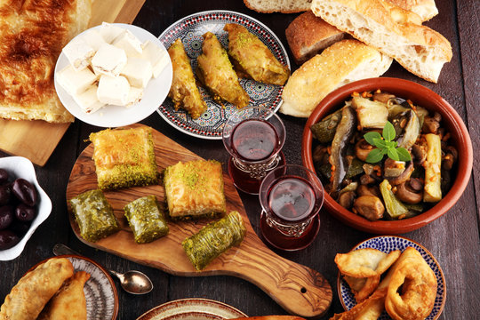 Middle eastern or arabic dishes and assorted meze, concrete rustic background. sambusak. Turkish Dessert Baklava with pistachio. Sarma. Halal food. Lebanese