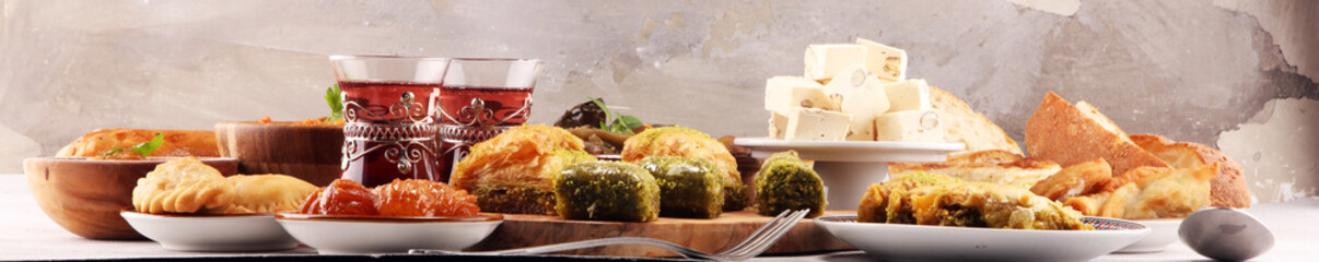Middle eastern or arabic dishes and assorted meze, concrete rustic background. sambusak. Turkish Dessert Baklava with pistachio. Sarma. Halal food. Lebanese