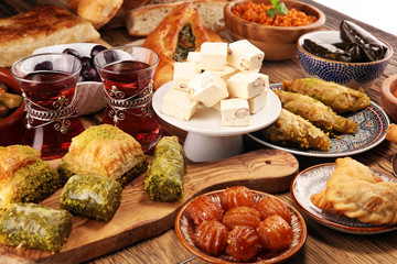 Middle eastern or arabic dishes and assorted meze, concrete rustic background. sambusak. Turkish Dessert Baklava with pistachio. Sarma. Halal food. Lebanese