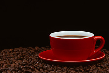Red coffee cup with coffee beans .