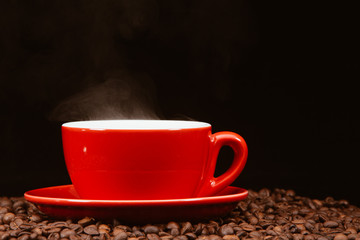 Red coffee cup with coffee beans .
