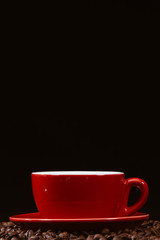 Red coffee cup with coffee beans.