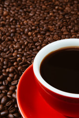 Red coffee cup with coffee beans .