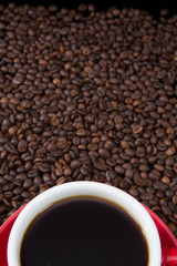 Red coffee cup with coffee beans.