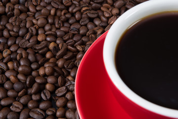 Red coffee cup with coffee beans.