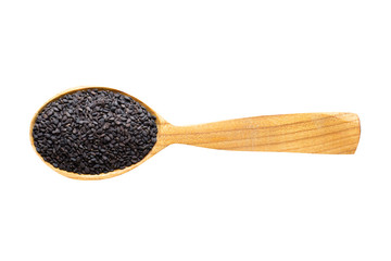 black sesame seeds in wooden spoon isolated on white background. spice for cooking food, top view.