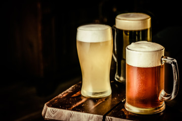 Selection of different types of beer in glasses in pub background