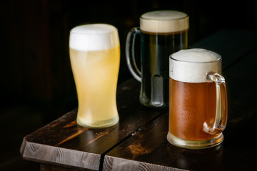 Selection of different types of beer in glasses in pub background