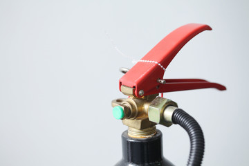 Close up fire extinguisher with safety on white background