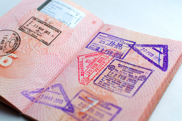 Fototapeta premium Russian passport stamped on border crossing. Departure and arrival immigration stamps.
