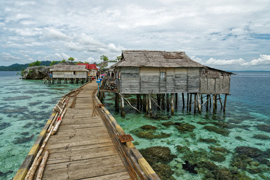 View of traditional bajo village with bridge and wooden houses on the Togean islands in Central Sulawesi, Indonesia