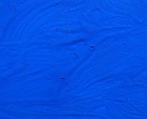 Deep blue watercolor paint graphic art pattern on textured paper background 