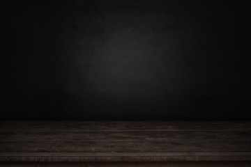 old wood table in front of dark and gray abstract  cement wall and studio room gradient background