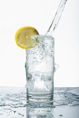 Pouring water into drinking glass