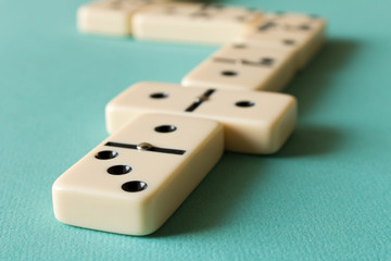 Playing dominoes on a light background . The concept of the game of dominoes. Close up