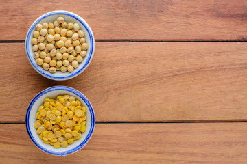 Soy beans and peeled soy beans in bowl on wooden table  with copy space.