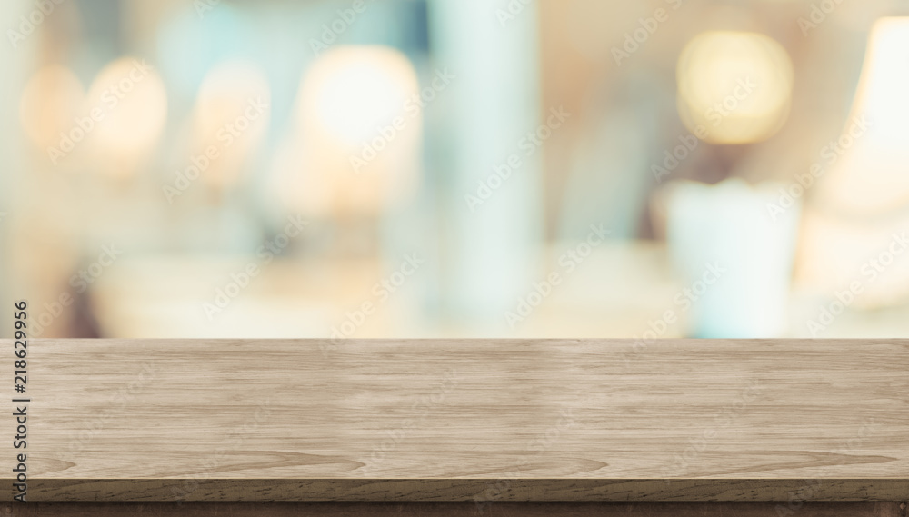 Aufkleber Empty rustic wood table and blurred soft light table in restaurant with bokeh background. product display template.Business presentation.