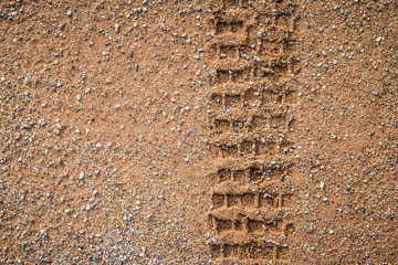motorcycle and car tire track print on sand with selective focus
