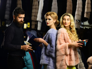 Man and girls with confident faces hold wallets