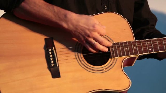Playing On The Acoustic Guitar. Musical Instrument With Guitarist Hands. Musician In Night Club.