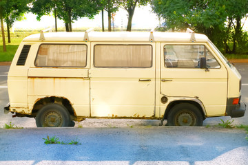 old and rusty yellow minivan
