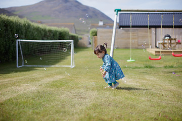 baby girl play bubble at Summer garden