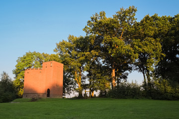 Sun is setting at the water tower of Ootmarsum (Overijssel, The Netherlands). Build in 1934, it...