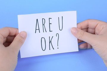 Woman's hand holding card with words 