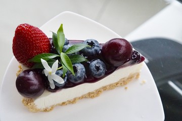 Eating mixed berries fruits cheese tart