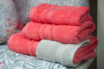 Fototapeta na wymiar closeup of red bath towels pile in store showroom