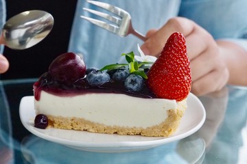 Eating mixed berries fruits cheese tart