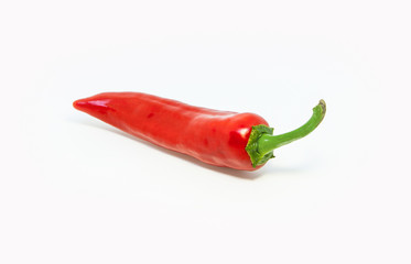 Chili. Two red pepper with a green tail on a light background. Bright and spicy vegetable.