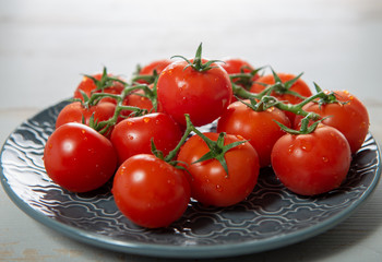 grape of cherry tomatoes on the blue plate
