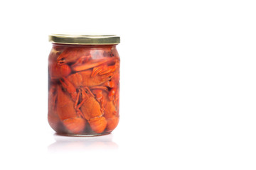 Crayfish boiled in a glass jar, on a white background.