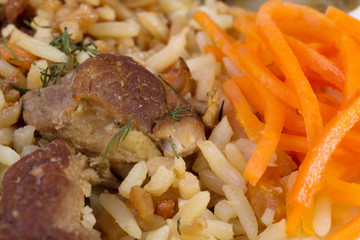 Traditional asia pilaf with beef and carrots close-up