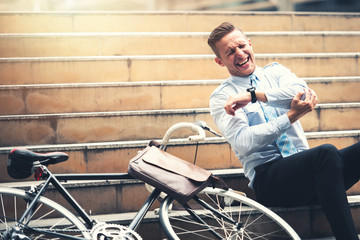 Fototapeta na wymiar Bicycle Accident on Young Businessman who Riding to Work on Urban Street in Rush Hour - Emergency Concept