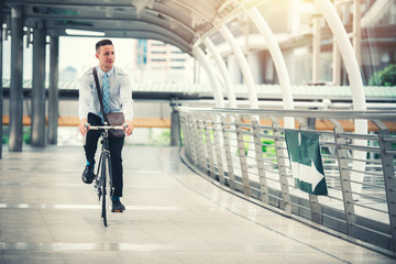 Young Businessman Riding Bicycle on Urban Street to Work in Rush Hour - Eco Friendly and Lifestyle Concept