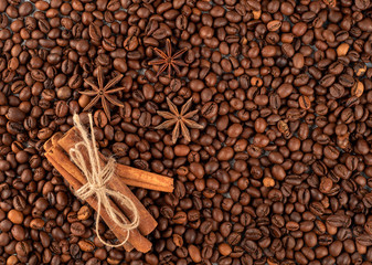 Roasted coffee beans witn cinnamon and anise, can be used as a background. selective focus