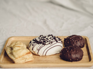 Set of chocolate donuts and puff pie.