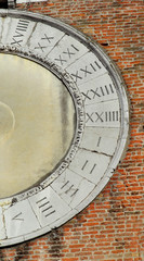 Ancient times. Roman numbers on an old medieval clock face