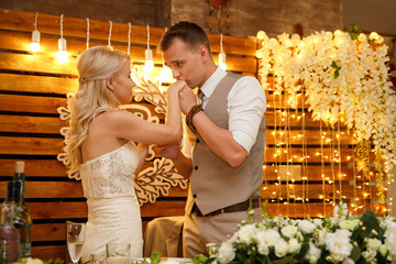 Wedding. Kissing bride and groom after cutting wedding cake