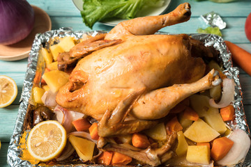 Roast chicken on the wooden table