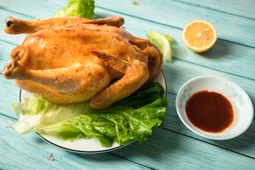 Roast chicken on the wooden table