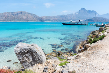 Views across the Bay to the island of Gramvoussa. Tourist ship at the pier. © KVN1777