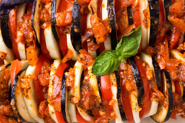 Baked vegetables (tomatoes, aubergines, zucchini) in the oven.