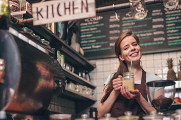 Smiling girl with smoothie