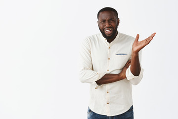 Get out of my way. Portrait of displeased pissed African American man in white shirt, waving with...