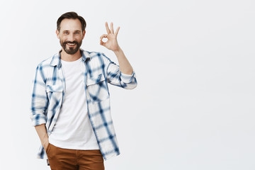 Happpy business partner having work under control. Charming fit mature male with beard and dark...