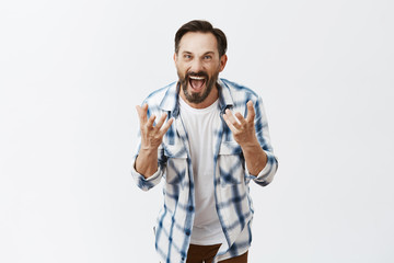 Guy being cheated on, feeling mad and angry, shouting at guilty wife, shaking palms in anger and...