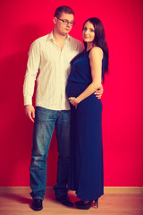 Pregnant woman with big belly and man posing.